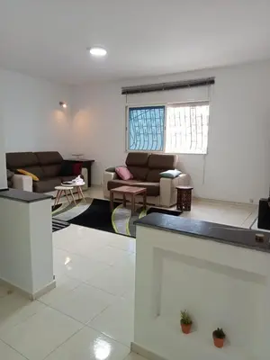 a living room with two couches and a table at Maison indépendante 100m2 à Témara centre in Temara