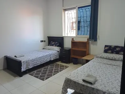 a room with two beds and a window at Maison indépendante 100m2 à Témara centre in Temara