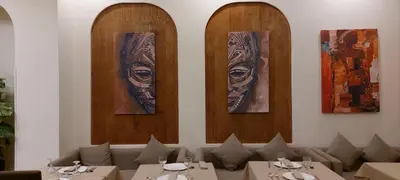 a dining room with tables and portraits on the wall at Unico Hotel & Spa Casablanca in Casablanca