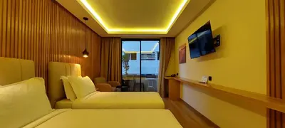 a hotel room with two beds and a television at Unico Hotel & Spa Casablanca in Casablanca
