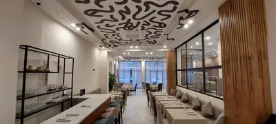 a restaurant with a long line of tables and chairs at Unico Hotel & Spa Casablanca in Casablanca
