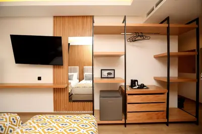 a room with a bedroom with a bed and a tv at Unico Hotel & Spa Casablanca in Casablanca