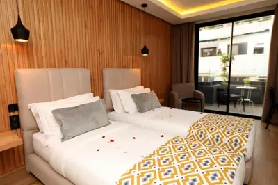 a hotel room with two beds and a window at Unico Hotel & Spa Casablanca in Casablanca