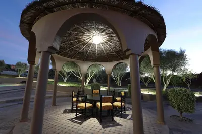 a gazebo with a table and chairs under it at Villa Tizra - Guest house in AÃ¯n el Ksob