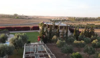 an aerial view of a garden with a playground at Villa Tizra - Guest house in AÃ¯n el Ksob