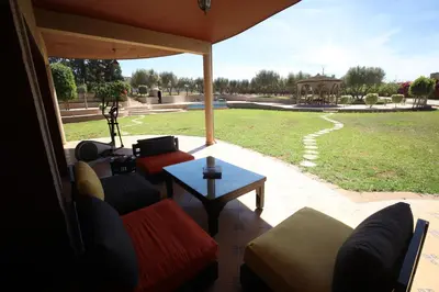 a living room with two couches and a table at Villa Tizra - Guest house in AÃ¯n el Ksob