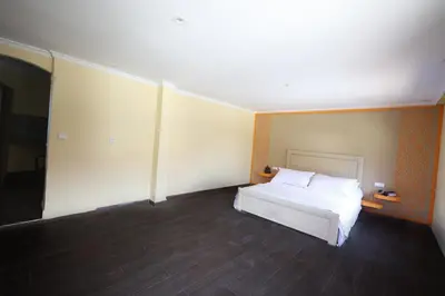 a bedroom with a white bed in a room at Villa Tizra - Guest house in AÃ¯n el Ksob