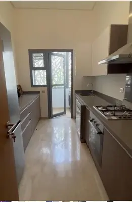 a kitchen with a stove and a counter top at 2 Bed Apartment - Balcony Parking Wifi in Casablanca