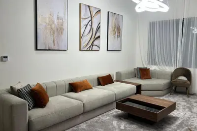 a living room with a couch and a table at 2 Bed Apartment - Balcony Parking Wifi in Casablanca