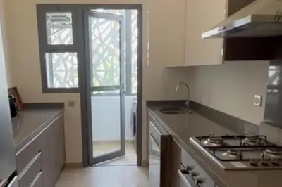 a kitchen with a stove and a glass door at 2 Bed Apartment - Balcony Parking Wifi in Casablanca