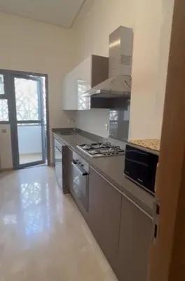 a kitchen with a stove and a counter top at 2 Bed Apartment - Balcony Parking Wifi in Casablanca