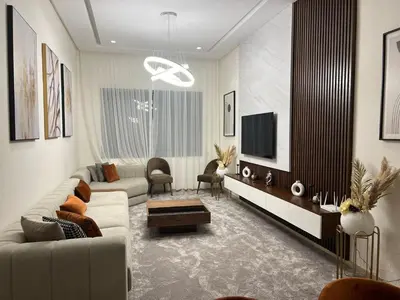 a living room with a couch and a tv at 2 Bed Apartment - Balcony Parking Wifi in Casablanca