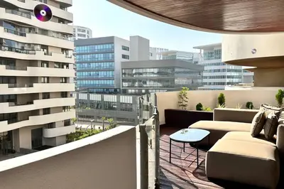 a balcony with couches and a table on a building at Marina State of Peace - Sea View in Casablanca