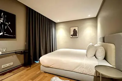a hotel room with a bed and a table in it at Marina State of Peace - Sea View in Casablanca