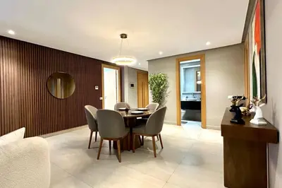 a dining room with a table and chairs at Marina State of Peace - Sea View in Casablanca