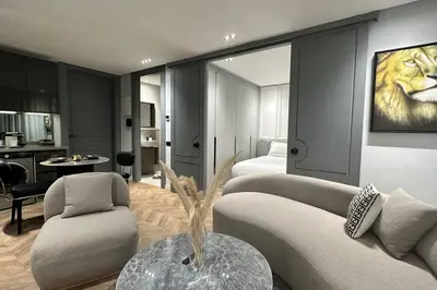a living room with a lion painting on the wall at Touch of Luxury - By AppartAli in Casablanca