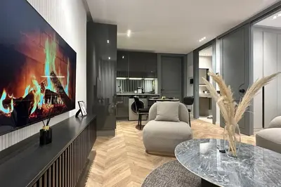a living room with a tv on a wall at Touch of Luxury - By AppartAli in Casablanca