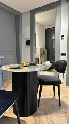 a kitchen with a table and two chairs in a room at Touch of Luxury - By AppartAli in Casablanca