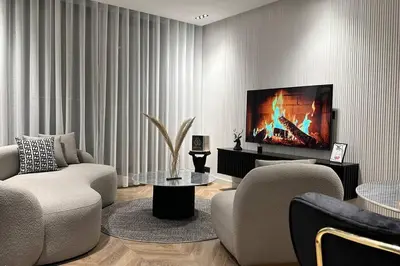 a living room with a couch and a tv at Touch of Luxury - By AppartAli in Casablanca