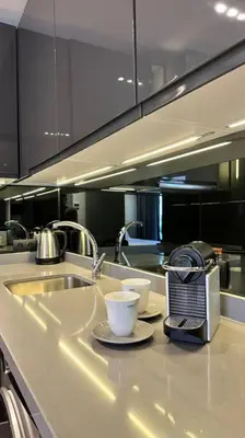a kitchen with a sink and two cups on a counter at Touch of Luxury - By AppartAli in Casablanca