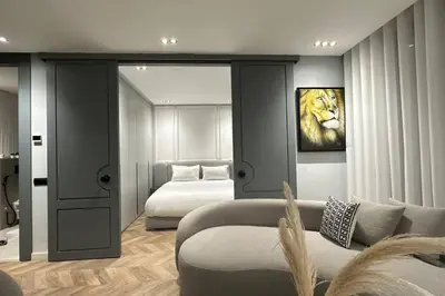 a bedroom with a bed and a lion painting on the wall at Touch of Luxury - By AppartAli in Casablanca