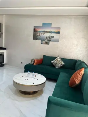 a living room with a green couch and a coffee table at maarif elite suite in Casablanca