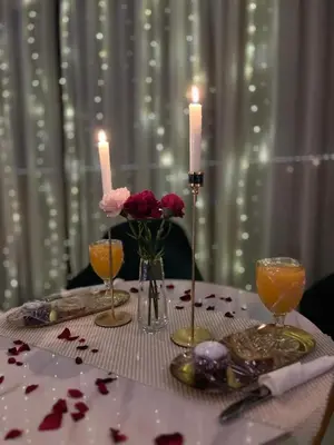 a table with two candles and flowers on it at maarif elite suite in Casablanca