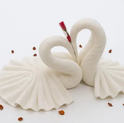 two white swans shaped like hearts on a white background at maarif elite suite in Casablanca