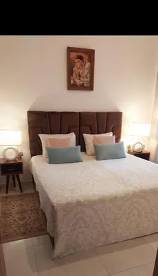 a bedroom with a large bed with two pillows at Idéal séjour Cozy aprt bouznika piscine et plage in Bouznika