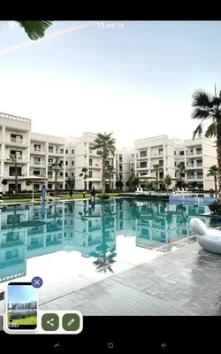a large swimming pool in front of a large building at Idéal séjour Cozy aprt bouznika piscine et plage in Bouznika