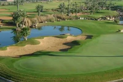 an aerial view of a golf course with a pond at Idéal séjour Cozy aprt bouznika piscine et plage in Bouznika