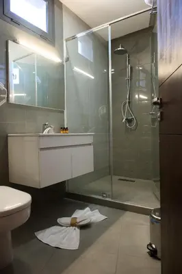 a bathroom with a shower and a sink and a toilet at Fourteen Hotel Ain Sebaa in Casablanca