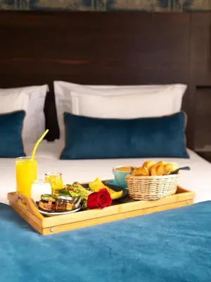 a tray of food on top of a bed at Fourteen Hotel Ain Sebaa in Casablanca