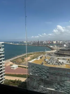 a view of a city and the ocean from a building at Panoramic View from 14th floor in Casablanca