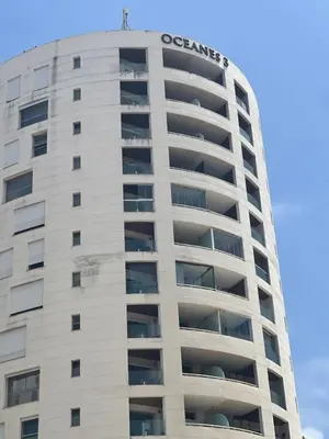a tall white building with the logo on top of it at Panoramic View from 14th floor in Casablanca