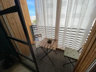 a table and chairs on a balcony with a window at Loft51 in Casablanca