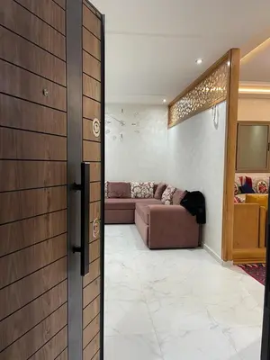 a living room with a couch and a sliding door at Chez Soad in Bouznika