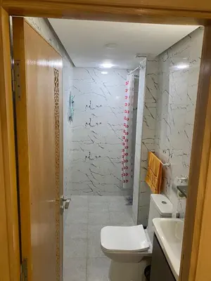 a bathroom with a shower and a toilet and a sink at Chez Soad in Bouznika