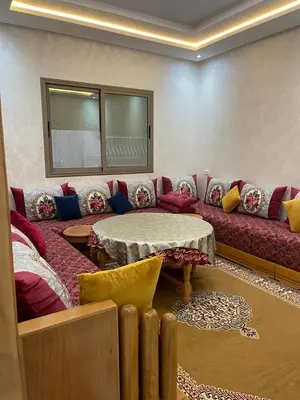 a living room with a couch and a table at Chez Soad in Bouznika