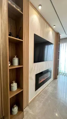 a living room with a fireplace with a flat screen tv at The Address - Sunny Anfa Hills in Casablanca
