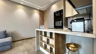 a kitchen with a counter with a microwave and a couch at The Address - Sunny Anfa Hills in Casablanca