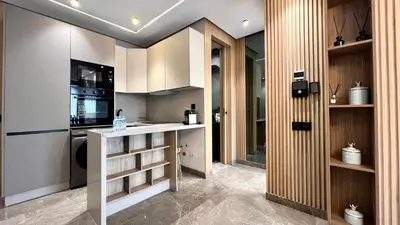 a kitchen with white cabinets and a counter top at The Address - Sunny Anfa Hills in Casablanca