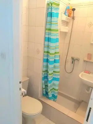 a bathroom with a shower with a toilet and a sink at Mi mini estudio 1 in Rabat