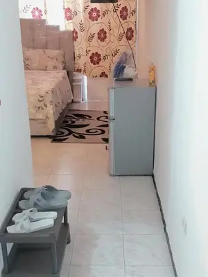 a kitchen with a refrigerator and a table in a room at Mi mini estudio 1 in Rabat