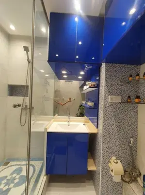 a blue bathroom with a sink and a shower at Grand Appartement corniche in Casablanca