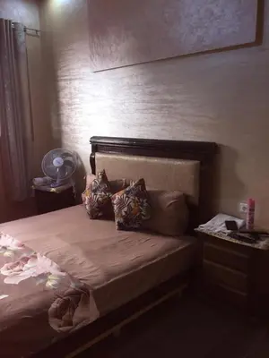 a bed with pillows on it in a bedroom at Airport M V chambre stay in Deroua