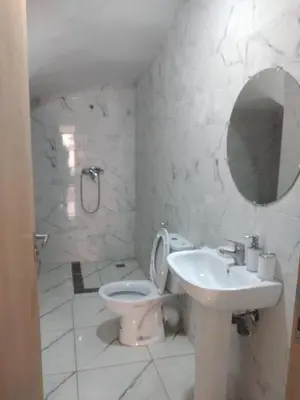 a bathroom with a sink and a toilet and a mirror at Airport M V chambre stay in Deroua
