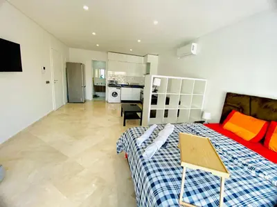 a large bedroom with a bed and a kitchen at Quiet Top-Floor Studio by Med Faculty & Tram Lines in Casablanca
