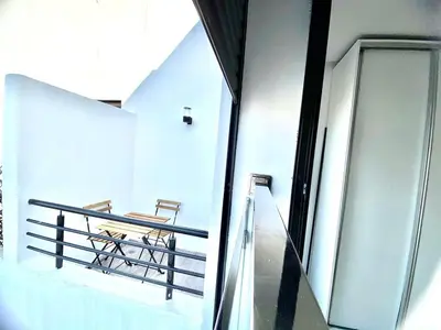 a balcony with a table and benches in a building at Quiet Top-Floor Studio by Med Faculty & Tram Lines in Casablanca