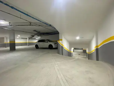 a parking garage with a white car parked in it at Quiet Top-Floor Studio by Med Faculty & Tram Lines in Casablanca